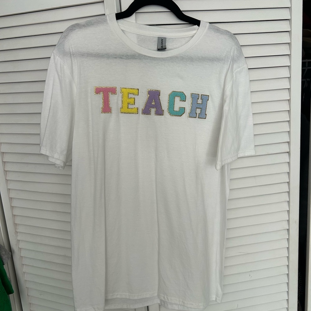 White T-Shirt with Multicolor 'TEACH' Design